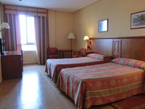 Postel nebo postele na pokoji v ubytování Hotel Lozano + 30 fotografií