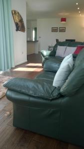 a couch with pillows on it in a living room at Stoneleigh Village in Sidmouth