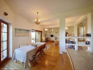 a dining room with a table and a living room at Studio Apartment Kvarner Gulf View in Opatija