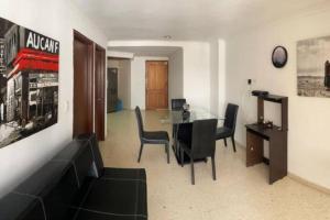 sala de estar con sofá y mesa con sillas en Oferta frente a la playa Cartagena . En, Sp, It., en Cartagena de Indias