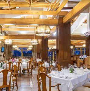 a dining room with white tables and chairs at Villa Four Seasons in Razlog