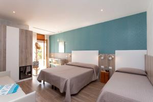 Postel nebo postele na pokoji v ubytování Hotel Rosa