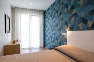 Postel nebo postele na pokoji v ubytování Hotel Rosa