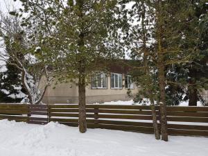 two trees in the snow in front of a house at Viirpuu puhkemaja in Kuressaare