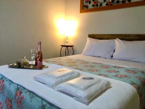 ein Schlafzimmer mit einem Bett mit zwei Handtüchern darauf in der Unterkunft Pousada Vovô Juca Tiradentes in Tiradentes