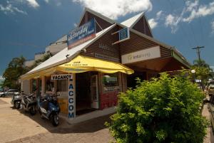 a motorcycle is parked in front of a restaurant at Whitsunday on The Beach in Airlie Beach