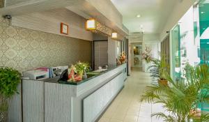 a lobby of a hotel with a counter and plants at Victoria Inn, Penang in George Town