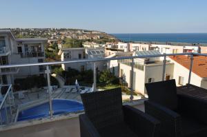 a view from the balcony of a house with a swimming pool at Beautiful family villa with sea view in Byala
