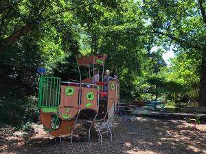 a group of people riding on a train in a park at Camping Moulin De Chaules in Saint-Constant