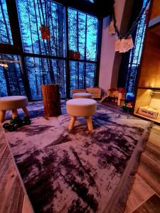 a room with three stools on a purple rug at Вила АРБОРЕТУМ in Teteven