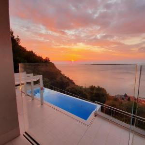 a view of the ocean from the balcony of a house at Bergeggi Tindari Sunrise in Bergeggi