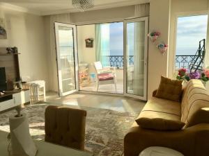 a living room with a couch and a television at Trabzon Sea Pearl in Trabzon