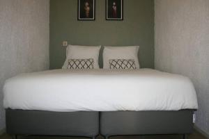 Postel nebo postele na pokoji v ubytování Knus familiehuisje nabij Bergen en Schoorl