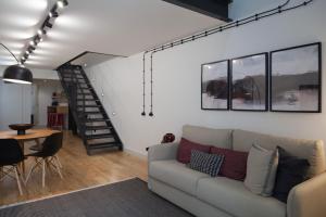 a living room with a couch and a table at FLH Intendente Industrial Design Duplex in Lisbon