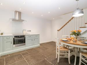 a kitchen with a table and a dining room at Willow Barn in Bridgwater