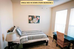 a bedroom with a bed and a table and a desk at Rosenberg, Richmond, Katy, 2 Story, 10 Beds - Coopers Hill in Rosenberg