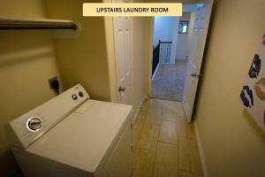 a laundry room with a washing machine and a hallway at Rosenberg, Richmond, Katy, 2 Story, 10 Beds - Coopers Hill in Rosenberg +26 photos
