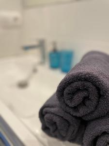 a pile of towels sitting on top of a sink at BalticSea Apartamenty in Sarbinowo