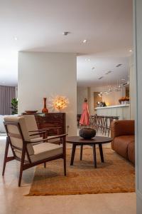 a living room with a table and a couch at Boutique Hotel Boškinac in Novalja