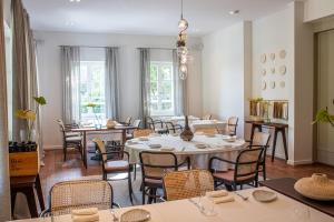 a dining room with tables and chairs at Boutique Hotel Boškinac in Novalja