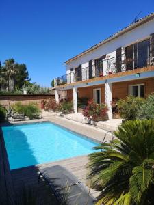 a swimming pool in front of a house at Escale villa in Marignane