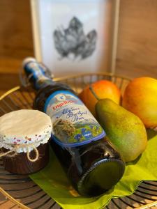 a bottle of beer and some fruit on a plate at Ferienwohnung mit eigenem Garten und Bergblick in Oy-Mittelberg