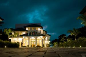 a large white house with a lit up facade at night at Lakegala Resort in Matale