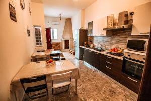 a large kitchen with a table and chairs in it at Villa Turicchio in Taranto