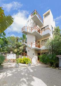 a building with balconies on the side of it at Los Amigos Tulum in Tulum