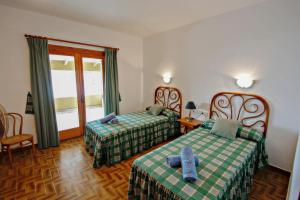 A bed or beds in a room at El Portet - beachfront holiday home with private pool in Moraira