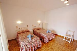 A bed or beds in a room at El Portet - beachfront holiday home with private pool in Moraira