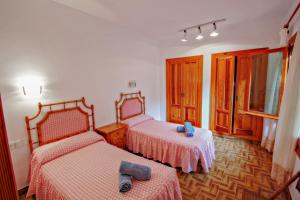 A bed or beds in a room at El Portet - beachfront holiday home with private pool in Moraira