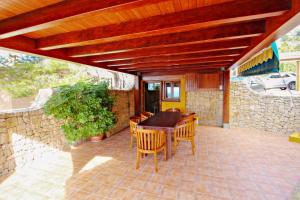 A television and/or entertainment centre at El Portet - beachfront holiday home with private pool in Moraira