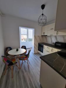 a kitchen with a table and chairs in a room at Apartament Central Iulia in Sibiu +14 photos