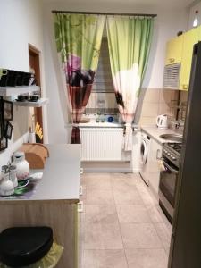 a kitchen with a white counter and a window at Przy Rynku in Duszniki Zdrój