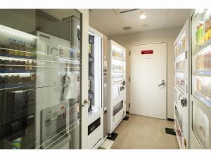a store aisle with a door and a room with drinks at Richmond Hotel Utsunomiya-ekimae in Utsunomiya