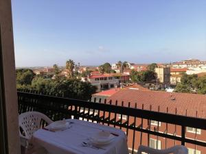 a table on a balcony with a view of a city at LAMEZIA AIRPORT APPARTMENT. in SantʼEufemia Lamezia