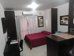 a bedroom with a red bed in a room at Abasto House in Rosario