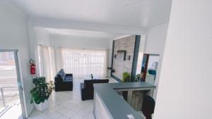 a living room with a table and chairs in a building at Nacional Park Hotel Lages in Lages