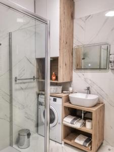 a bathroom with a sink and a washing machine at Studio Apartment "Brigita",free parking in Rijeka +75 photos