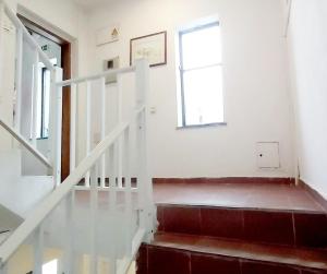 a staircase in a house with a window at Residencia do Parque in Odeceixe