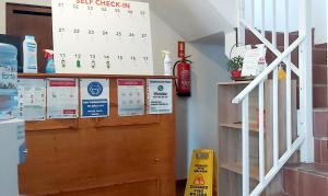 a calendar on a wall next to a staircase at Residencia do Parque in Odeceixe