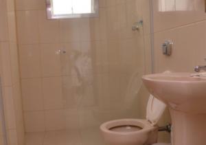 a bathroom with a shower and a toilet and a sink at Villa Maior Hotel in São Roque