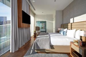 a bedroom with a large bed and a large window at The Dupont Circle Hotel in Washington, D.C.