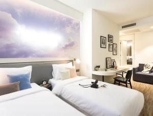 a hotel room with two beds and a desk at Anemon Bakırköy in Istanbul