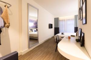 a hotel room with a bed and a mirror at Anemon Bakırköy in Istanbul