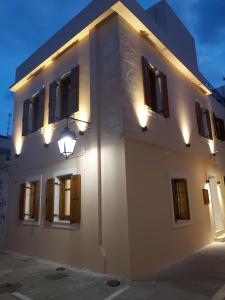 a white building with windows and lights on it at Palazzino d Irene in Rethymno Town