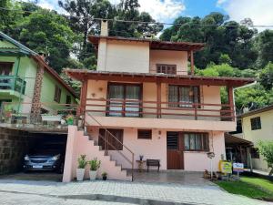 a house with a car parked in front of it at Apto Aconchegante na Serra Gaúcha in Nova Petrópolis