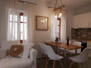 a living room with a white couch and a table at Palazzino d Irene in Rethymno Town