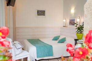 a bedroom with a bed and a chair and flowers at L'herbier d'Orange in Orange